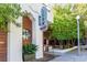 The building's exterior showcases wood accents, an arched entrance, and lush greenery, creating an inviting atmosphere at 104 Powell Cv, Decatur, GA 30030