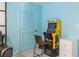 Corner in a game room with a Pac-Personal arcade machine, light blue walls, a door, and a white cabinet at 104 Powell Cv, Decatur, GA 30030