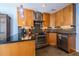 Modern kitchen with granite countertops, stainless steel appliances, wood cabinetry and view of stainless steel dishwasher at 104 Powell Cv, Decatur, GA 30030