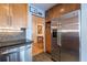 Modern kitchen featuring stainless steel appliances, wood cabinetry, and view into the adjacent stairway at 104 Powell Cv, Decatur, GA 30030