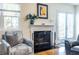 Cozy living room featuring a fireplace, comfortable seating, and natural light from the window at 104 Powell Cv, Decatur, GA 30030