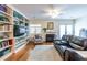 Bright living room featuring built-in shelving, a fireplace, hardwood floors, and comfortable seating at 104 Powell Cv, Decatur, GA 30030
