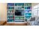 Comfortable living room features built-in shelving for storage and display, with natural light from the window at 104 Powell Cv, Decatur, GA 30030