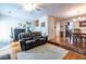 Open-concept living room featuring hardwood floors, comfortable seating, and direct access to the dining room at 104 Powell Cv, Decatur, GA 30030