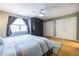 Spacious main bedroom features hardwood floors, large window, and ample closet space for storage at 104 Powell Cv, Decatur, GA 30030