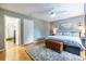 Comfortable main bedroom featuring hardwood floors, an area rug, and access to a modern en-suite bathroom at 104 Powell Cv, Decatur, GA 30030