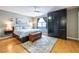 Serene main bedroom with a cozy area rug, dark built in storage, and a comfortable queen size bed at 104 Powell Cv, Decatur, GA 30030