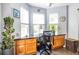 Bright office space with lots of natural light and a built-in desk with wooden cabinets, great for working from home at 104 Powell Cv, Decatur, GA 30030