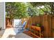 Cozy backyard patio featuring a wooden fence, mature trees, outdoor seating, and a storage shed at 104 Powell Cv, Decatur, GA 30030