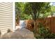 Outdoor patio with concrete and wooden areas, fenced with plants for privacy, and an outdoor storage bin at 104 Powell Cv, Decatur, GA 30030