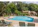 Inviting community pool surrounded by lounge chairs, lush greenery, and beautiful landscaping at 104 Powell Cv, Decatur, GA 30030