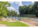 Outdoor tennis court with a black fence in a beautiful community; recreation and fun for all at 104 Powell Cv, Decatur, GA 30030