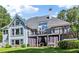 Exterior view of the home's back, featuring a balcony and covered patio at 1213 Grande Vw, Loganville, GA 30052
