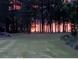 Scenic view of sunset through the trees in the expansive backyard at 1213 Grande Vw, Loganville, GA 30052