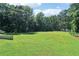 Expansive backyard featuring lush lawn and mature trees at 1213 Grande Vw, Loganville, GA 30052