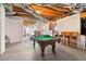 Spacious unfinished basement, great for storage, featuring an open ceiling and pool table at 1213 Grande Vw, Loganville, GA 30052