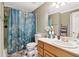 Cozy bathroom featuring a vanity with a sink and a shower with a blue floral shower curtain at 1213 Grande Vw, Loganville, GA 30052