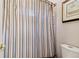 Bathroom featuring a toilet and a shower with a striped shower curtain at 1213 Grande Vw, Loganville, GA 30052