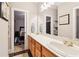 Bathroom featuring a double sink vanity, with a view to a bedroom on the other side at 1213 Grande Vw, Loganville, GA 30052