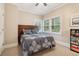 Comfortable bedroom featuring a bed with patterned bedding and natural light from the windows at 1213 Grande Vw, Loganville, GA 30052