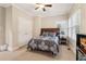 Relaxing bedroom features a bed with patterned bedding, and natural light from the windows at 1213 Grande Vw, Loganville, GA 30052