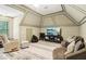 Versatile bonus room with comfortable seating, entertainment center, and vaulted ceilings at 1213 Grande Vw, Loganville, GA 30052