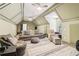A bonus room with comfortable seating arrangement, and vaulted ceilings at 1213 Grande Vw, Loganville, GA 30052