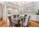 Sophisticated dining room featuring a modern glass table, six upholstered chairs, and elegant coffered ceilings at 1213 Grande Vw, Loganville, GA 30052
