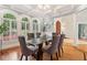 Sophisticated dining room featuring a modern glass table, six upholstered chairs, and elegant window shutters at 1213 Grande Vw, Loganville, GA 30052