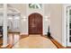 Elegant foyer with gleaming wood floors, a striking double door entry, and views of the dining room and abundant natural light at 1213 Grande Vw, Loganville, GA 30052