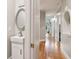 Inviting hallway featuring hardwood floors, archway details, and a powder room at 1213 Grande Vw, Loganville, GA 30052