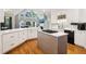 Modern kitchen with white cabinets, stainless appliances, and an island with a gas cooktop at 1213 Grande Vw, Loganville, GA 30052