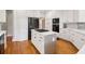 Modern kitchen with an island, white cabinets and stainless appliances at 1213 Grande Vw, Loganville, GA 30052