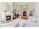 Bright living room with fireplace, hardwood floors, and tall windows offering lots of natural light at 1213 Grande Vw, Loganville, GA 30052