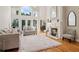 Bright living room with soaring ceilings, large arched windows, and a cozy fireplace, creating an inviting atmosphere at 1213 Grande Vw, Loganville, GA 30052