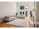 Bright living room with soaring ceilings, large arched windows, and a cozy fireplace, creating an inviting atmosphere at 1213 Grande Vw, Loganville, GA 30052