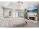 Inviting main bedroom features a fireplace, trey ceiling, and serene decor at 1213 Grande Vw, Loganville, GA 30052