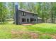 Back exterior of home featuring a spacious yard, patio, and neutral siding at 155 N Fayette Dr, Fayetteville, GA 30214