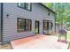 Rear exterior view of home with patio, neutral siding, and large windows at 155 N Fayette Dr, Fayetteville, GA 30214