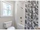 This bathroom showcases a subway tile shower with bronze fixtures and a patterned shower curtain at 155 N Fayette Dr, Fayetteville, GA 30214