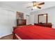 Bedroom featuring a bed with red bedding, wood floors, and a ceiling fan at 155 N Fayette Dr, Fayetteville, GA 30214