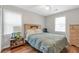 Bedroom showcasing a bed, wood floors, natural lighting, and neutral paint throughout at 155 N Fayette Dr, Fayetteville, GA 30214