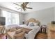 Bedroom featuring a bed with neutral bedding, wood floors, and a chaise lounge at 155 N Fayette Dr, Fayetteville, GA 30214