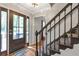 Welcoming entryway with hardwood floors and an elegant staircase with rod iron railings at 155 N Fayette Dr, Fayetteville, GA 30214