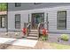Elegant front entrance featuring a wooden door, gray siding and well-maintained landscaping at 155 N Fayette Dr, Fayetteville, GA 30214