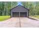Two-car detached garage with matching siding and a spacious concrete driveway at 155 N Fayette Dr, Fayetteville, GA 30214