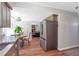 Open kitchen layout flowing into the breakfast nook and living area, with stainless steel fridge at 155 N Fayette Dr, Fayetteville, GA 30214