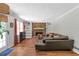 Living room with a brick fireplace, wood floors, and built-in shelving at 155 N Fayette Dr, Fayetteville, GA 30214