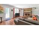 Bright living room featuring wood flooring, a cozy fireplace, and large windows at 155 N Fayette Dr, Fayetteville, GA 30214