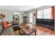 Open living room showcasing wood flooring, a stylish coffee table, and access to the kitchen at 155 N Fayette Dr, Fayetteville, GA 30214